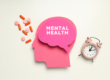 Head with brain that says mental health. Loose Pills Next to it and an alarm clock on the other side.