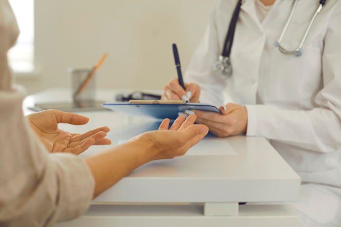 Woman talking to doctor